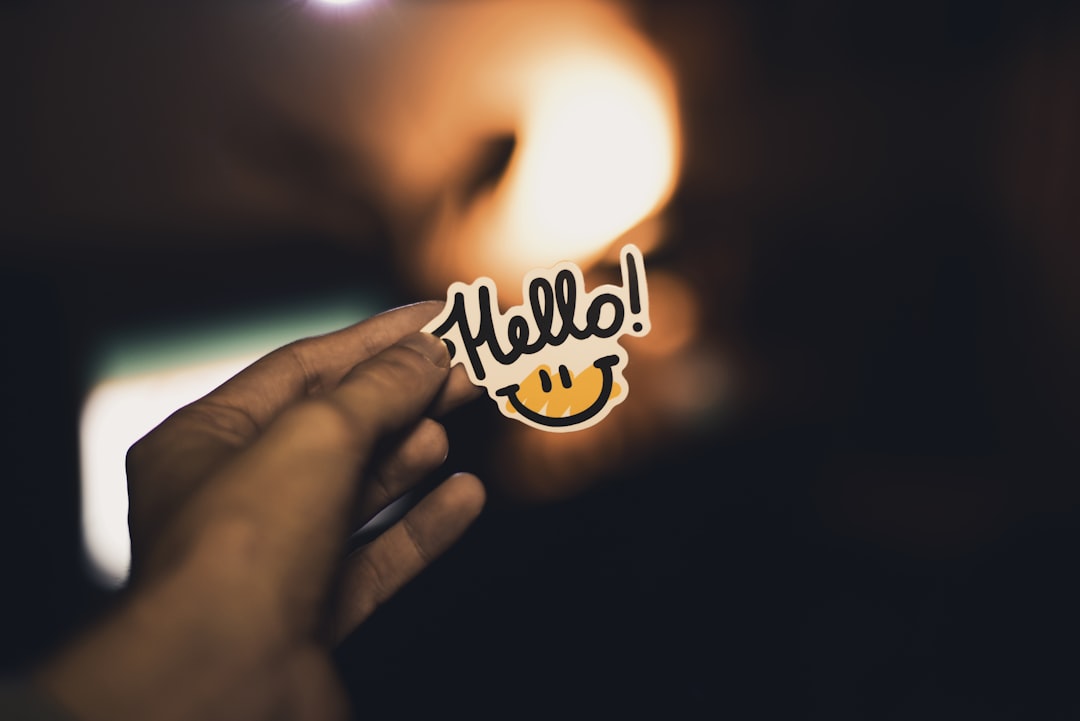 person holding Hello! sticker | Photo by Vladislav Klapin on Unsplash